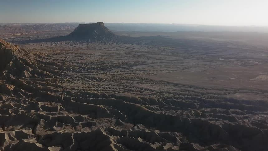 Large formations and dunes cover the brown landscape