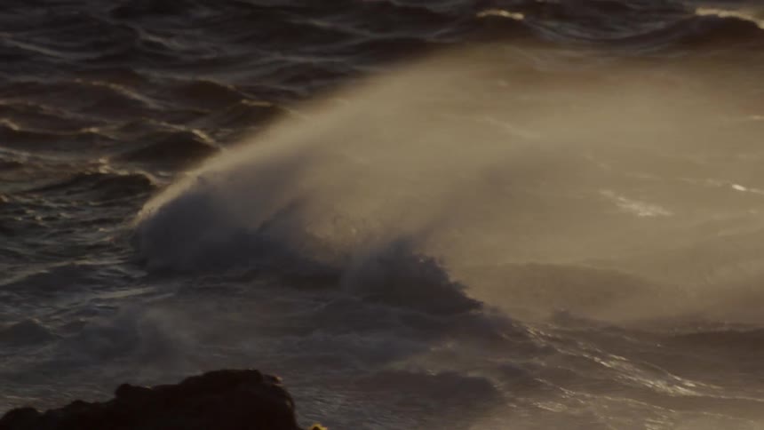 The large waves rage around near the shore