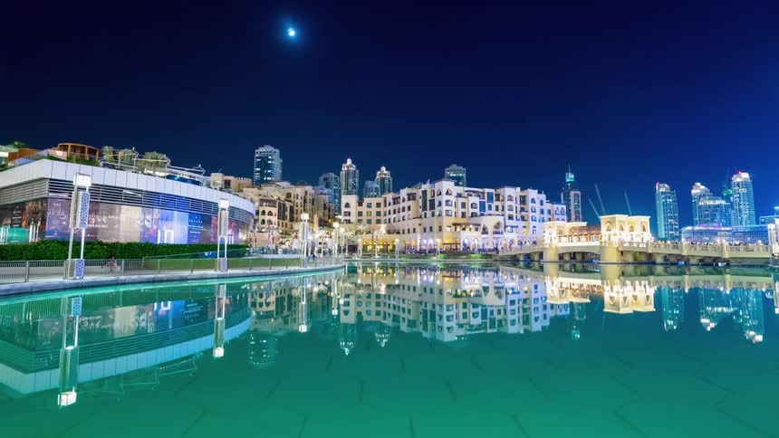 Large pool of water near a hotel at night