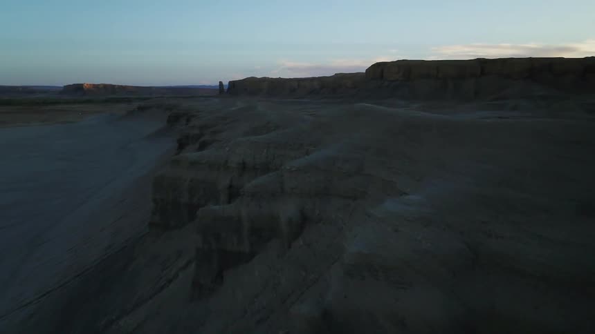 A person is standing on the tall rocks