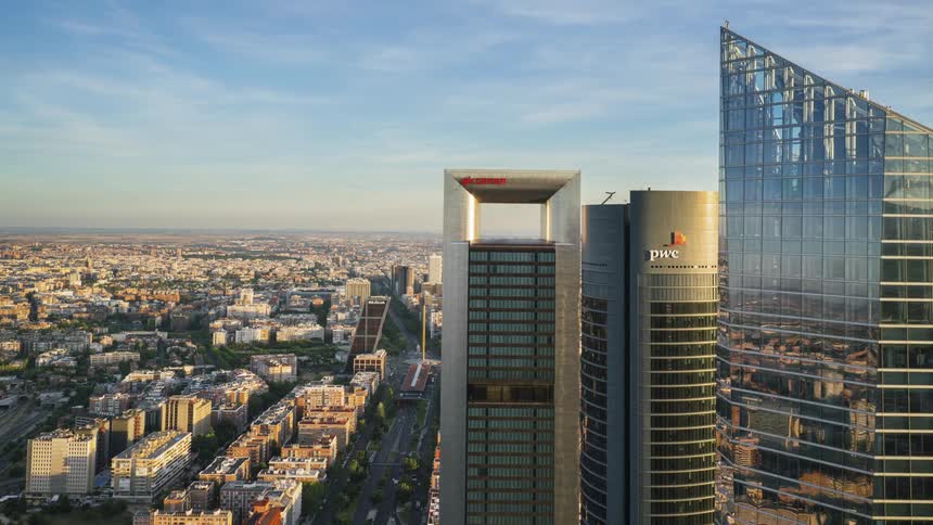 Tall glass skyscrapers tower into the sky