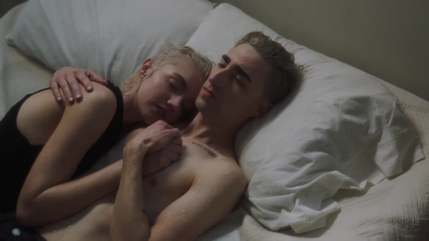 Man and woman sleep together in bed