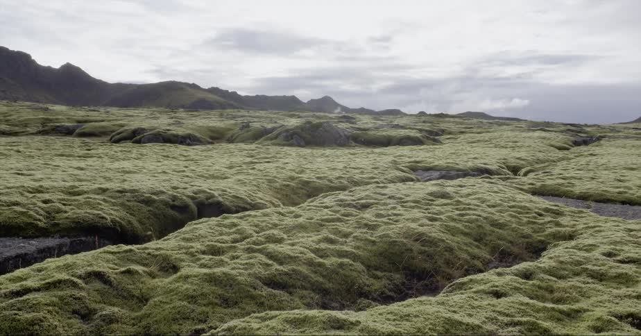 Hills sit under a cloudy sky