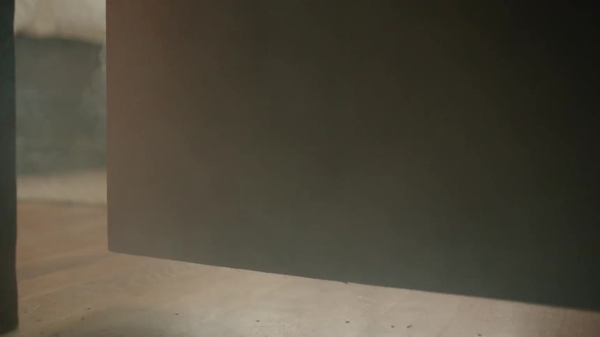 Smoke billows out from underneath a door