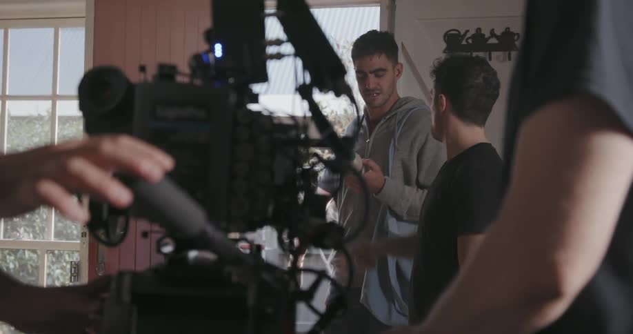 A film crew works inside a house