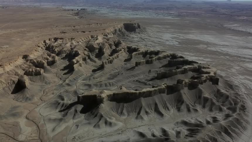 Dirt and hills cover a rural landscape