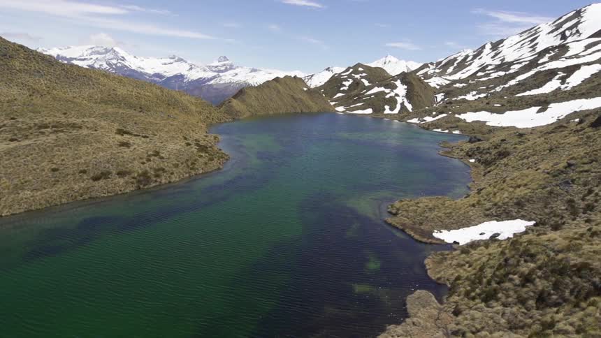 Snow-covered mountains surround a lake