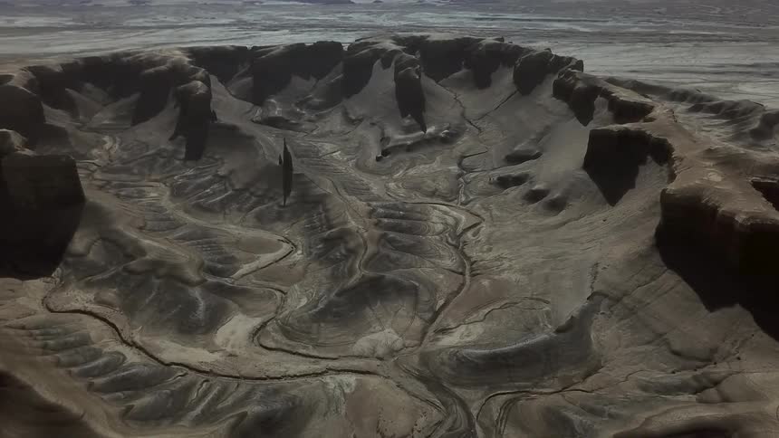 Dirt and hills cover a rural landscape