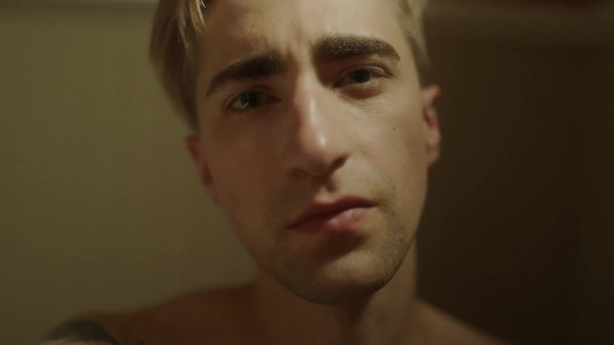 Man blinks his eyes as he stares intently