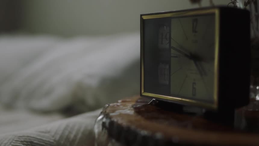 Water pours over a night stand by the bed
