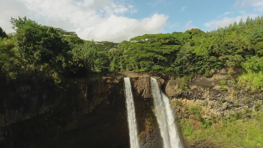 Water falls off the side of a cliff
