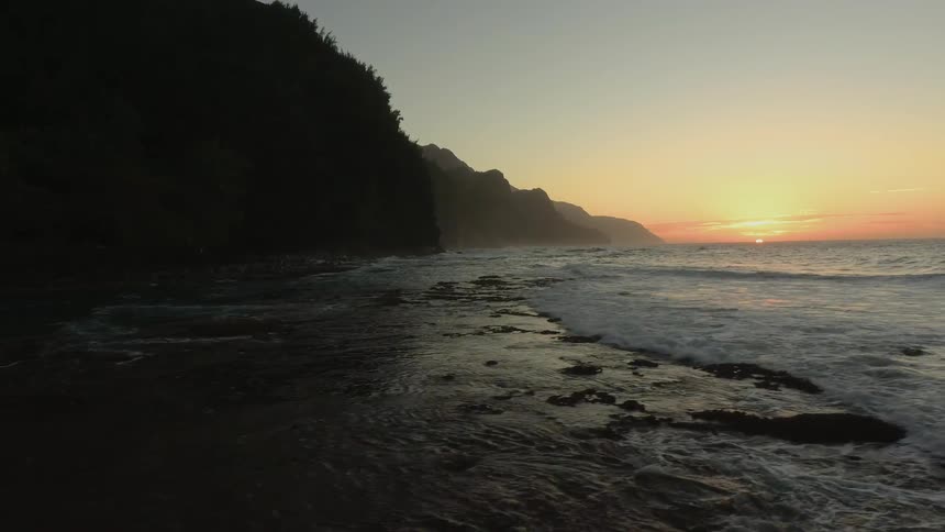 Ocean waves come to shore at sunset