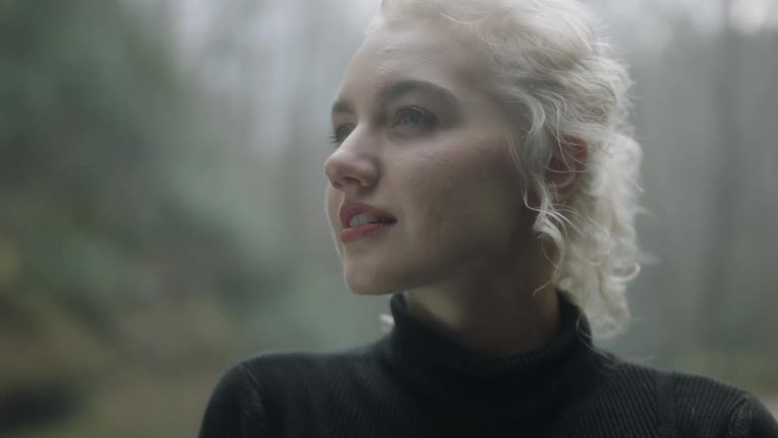 Blond woman smiles as she looks to her right