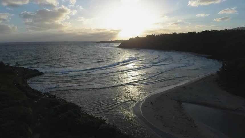 The tide flows onto the beach shore