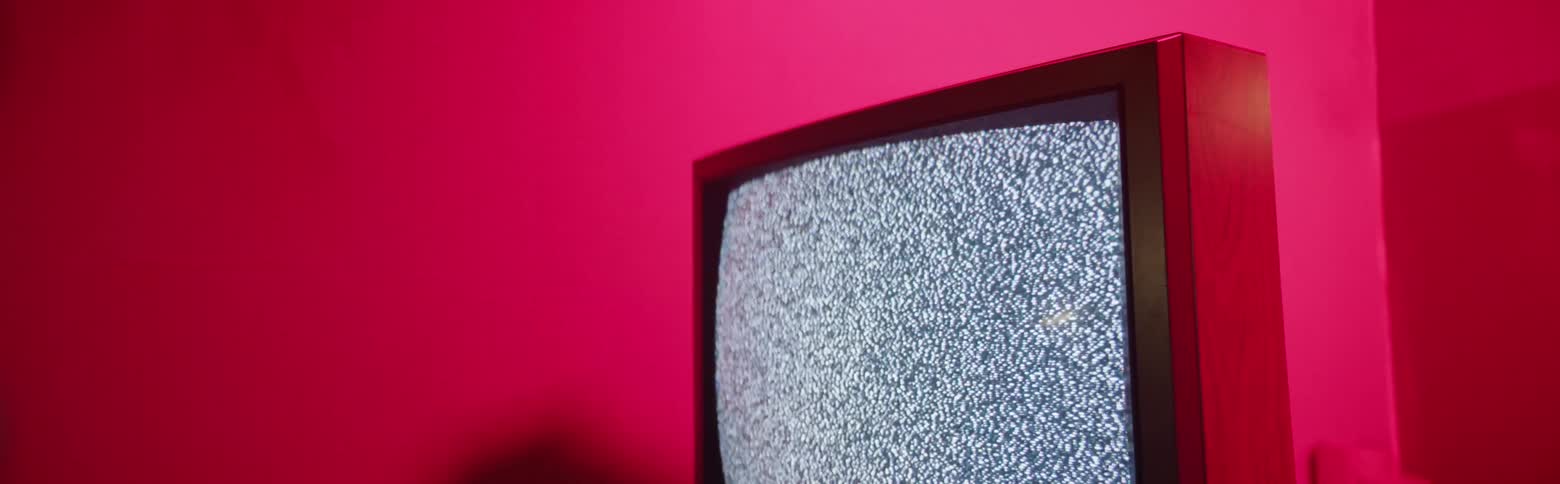 A television is showing static and snow before shutting down