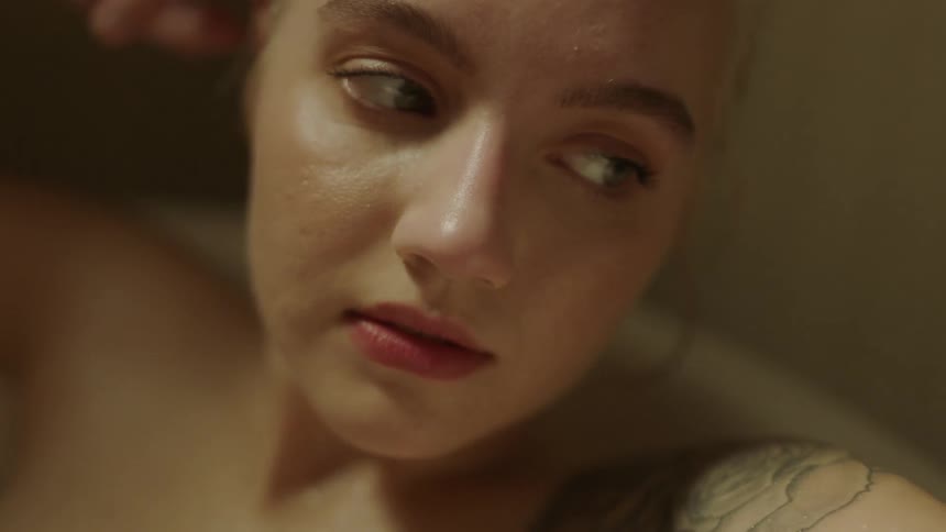 Woman blinks and turns her head