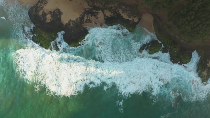 Ocean waves break as they come to shore
