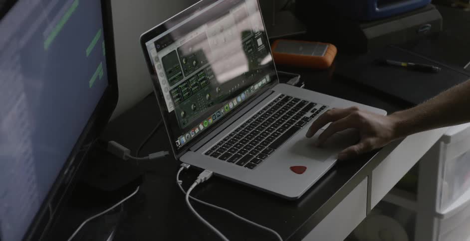Man scrolls on a laptop with his right hand