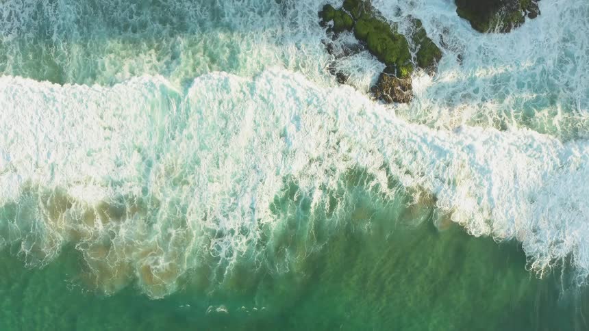 The tide flows onto the beach shore