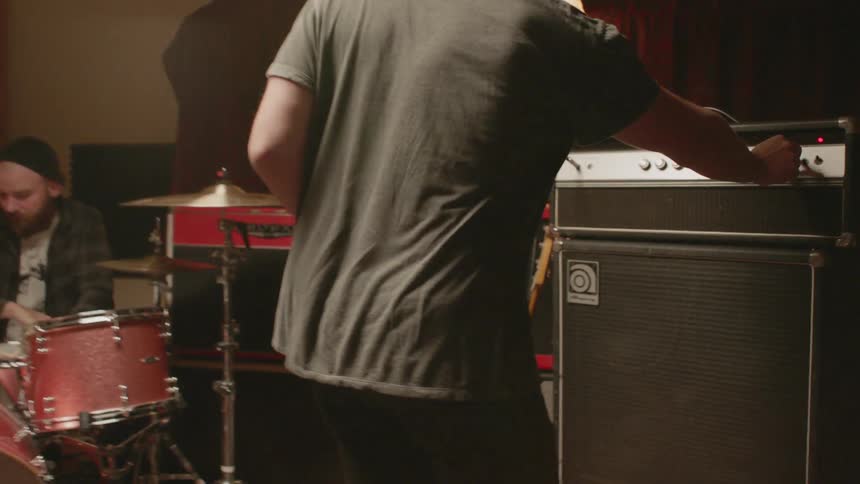 A man walks into a music rehearsal space