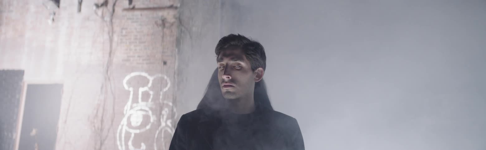 A man stands in an area filled with smoke