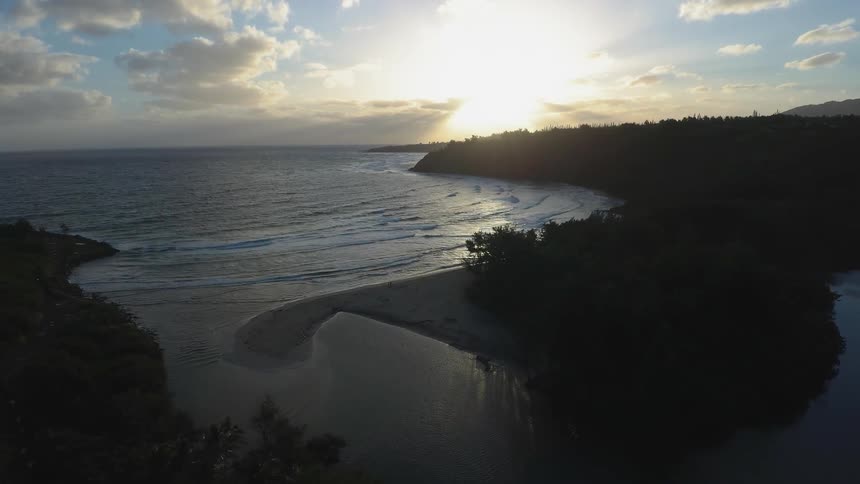 Sun sets over a large body of water