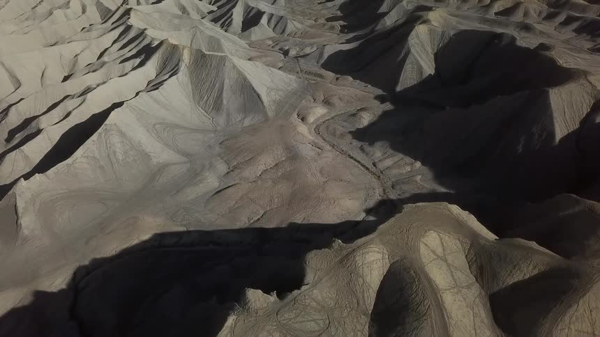 Shadows fall over hilly desert landscape