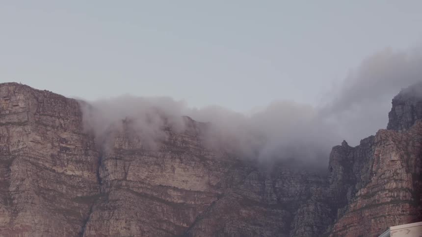 The fog rolls over the top of the mountain