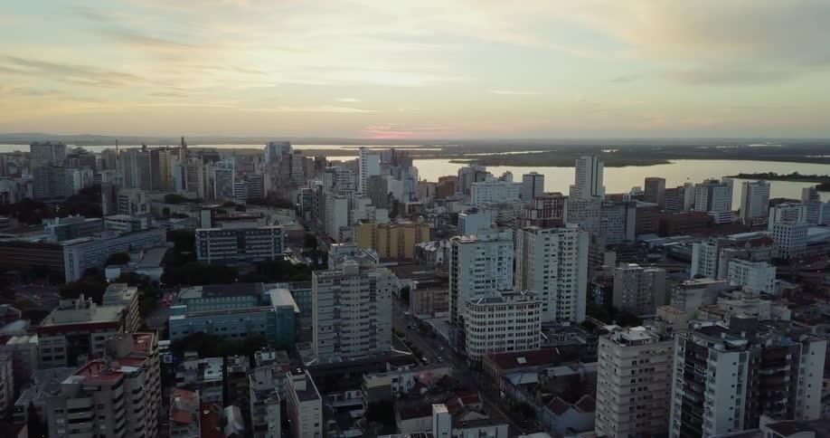 Buildings of a coastal city at sunset