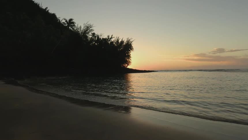 The tide flows onto the beach shore