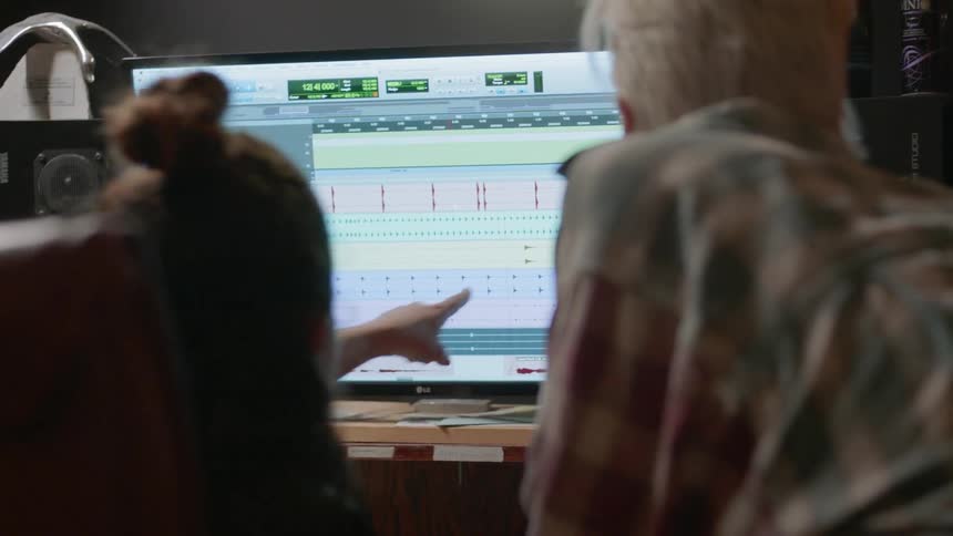 Two women work in a recording studio