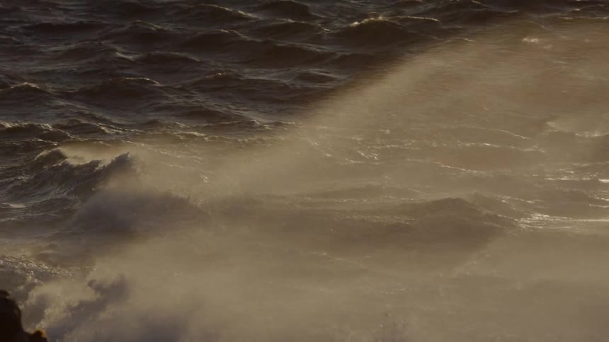 Water spraying up and misting at sunset