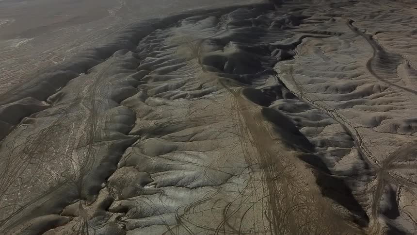 Sandy hilly landscape with paths running through
