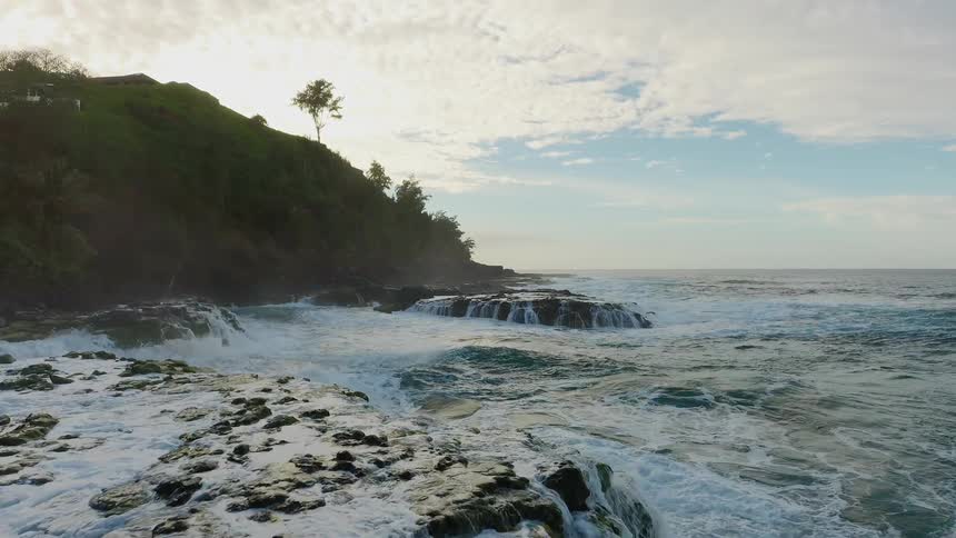 Ocean waves crash against the shore
