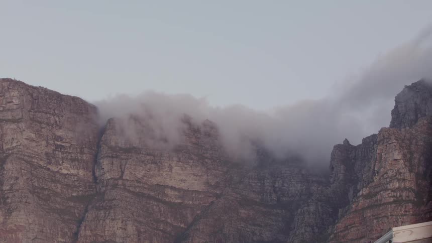 Fog is flowing and hovering over rock cliffs