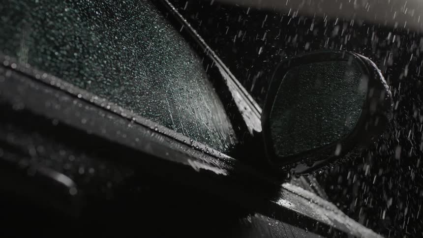 Rain falls onto the outside of the car