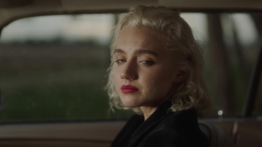 Sad woman sits in a car