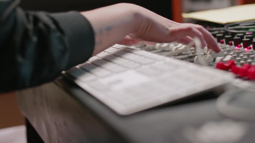 A musician works in a recording studio
