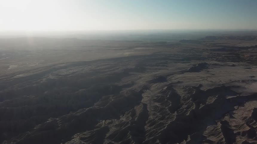 The sun shines on an open dune filled landscape