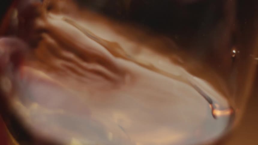 A drink is swirled in a glass