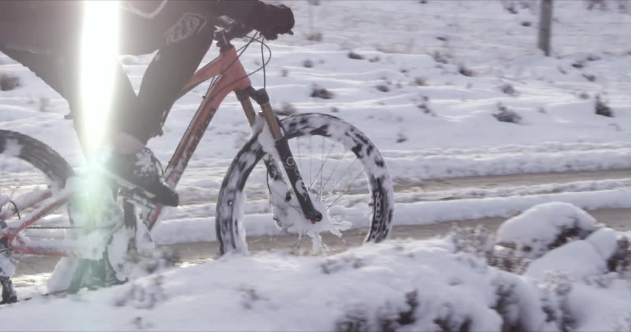 A person riding a dirt bike through snow