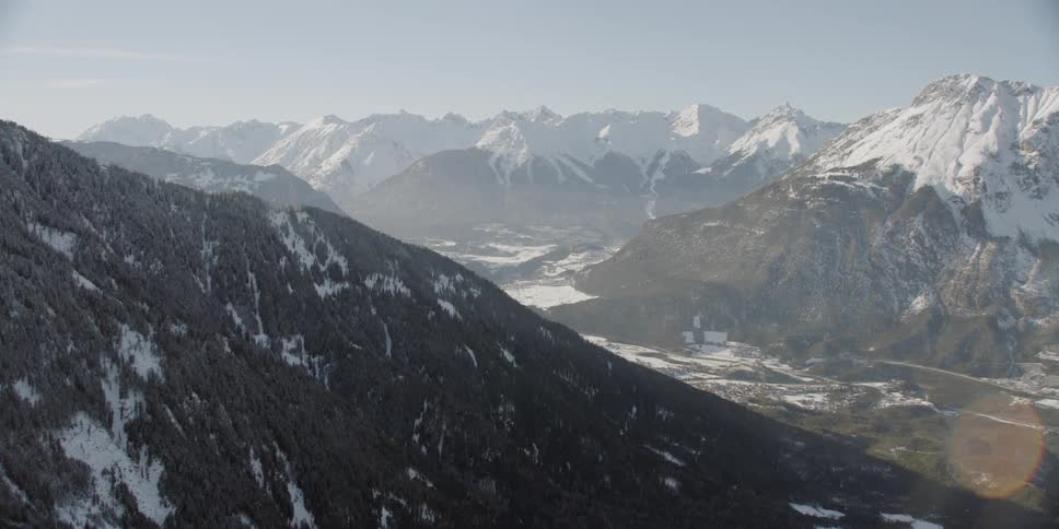 Snow covers mountains on a sunny day
