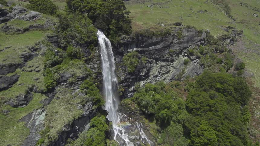 Aerial view of a waterfall splashing into a river