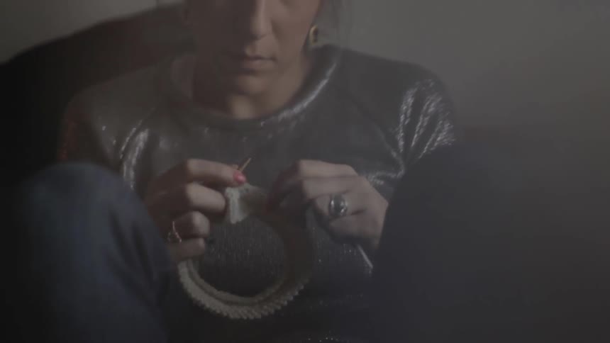 A woman is knitting