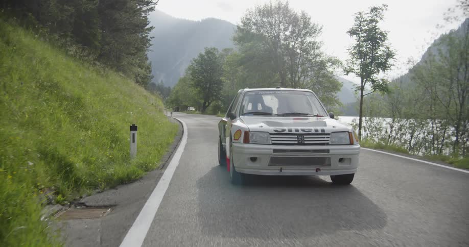 Person is driving a race car on a mountain road