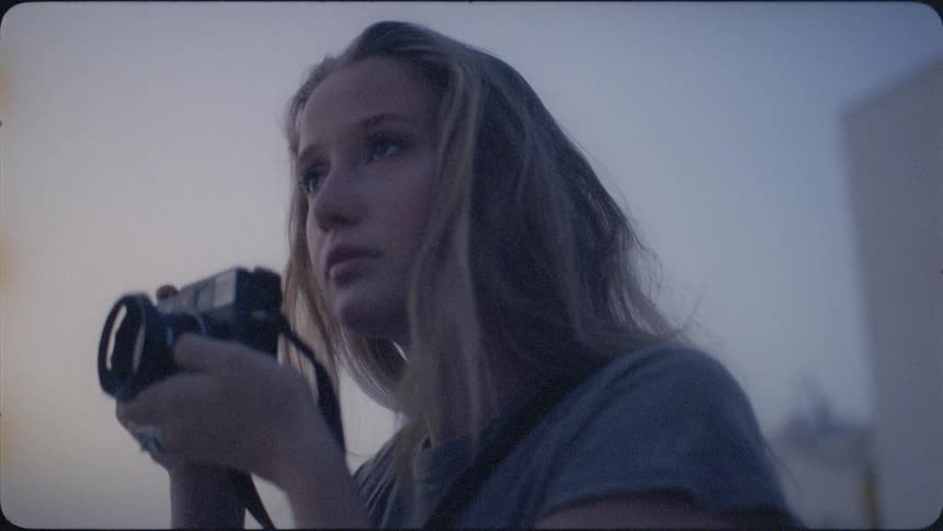 A woman takes photos outside