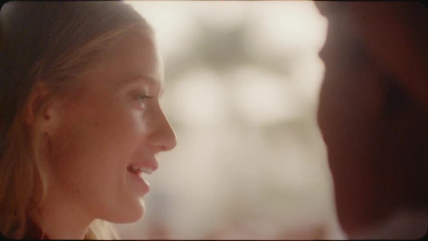 Woman smiles as she talks to a man