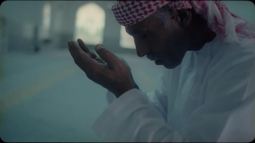Man recites a prayer on the floor