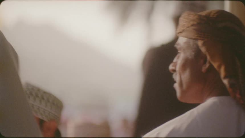 Man looks out across a crowd of people