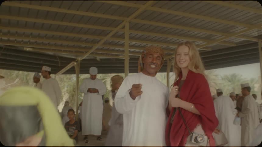 A woman talks to an arab man at a gathering